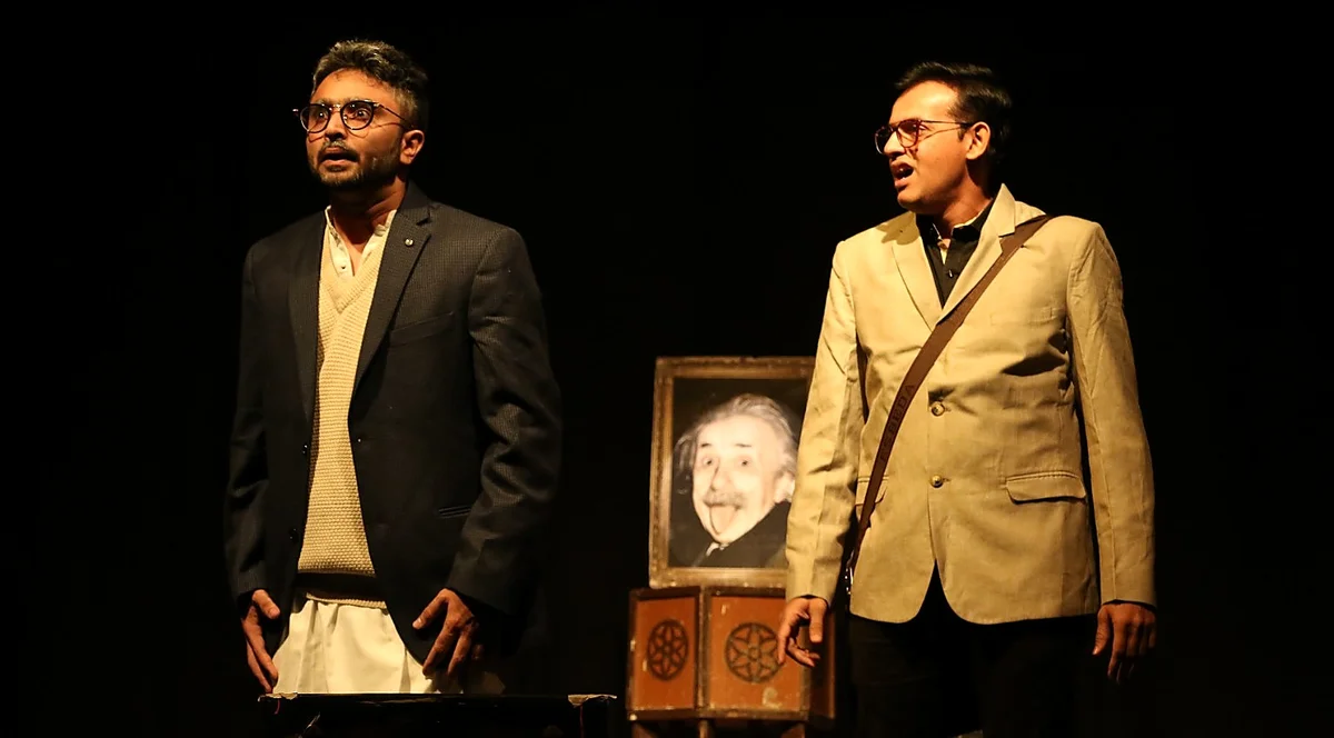Darshan Mahajan onstage bowing to auditorium